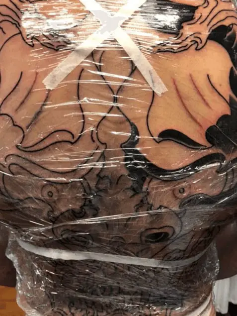 fresh tattoo covered with cling wrap