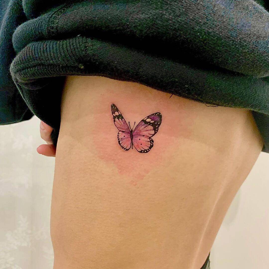 Colorful butterfly tattoo on thigh