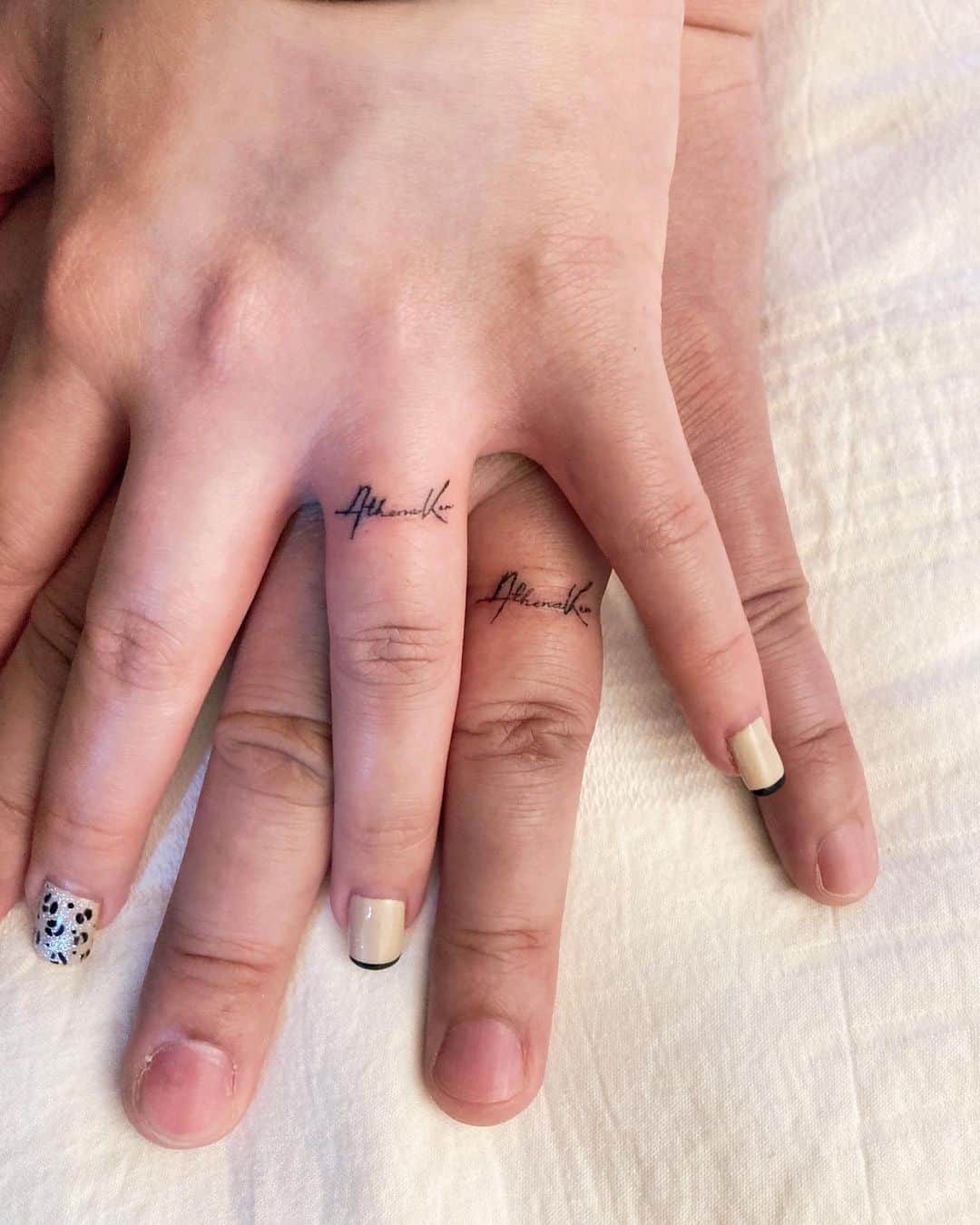 Calligraphy wedding tattoo on fingers