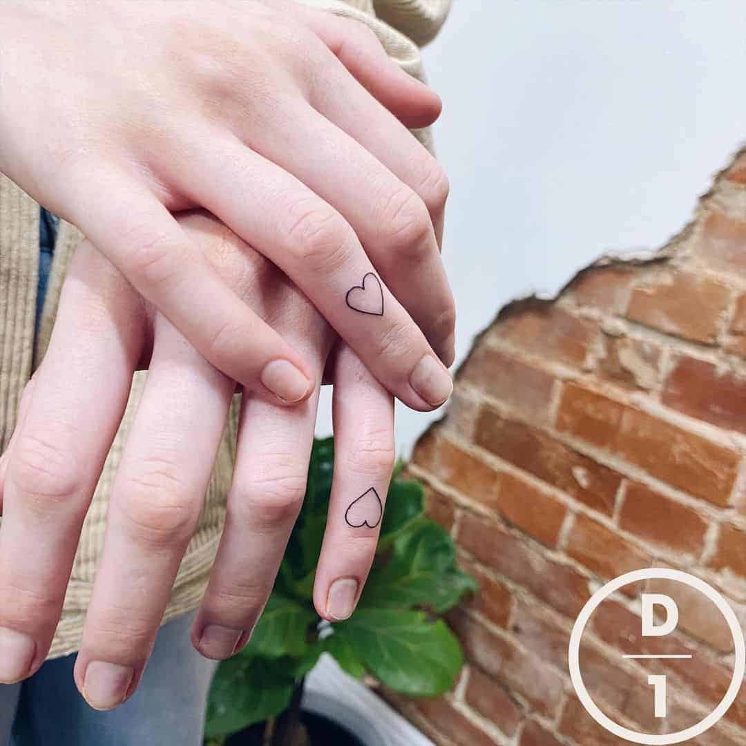 Cute hearts tattoo on fingers