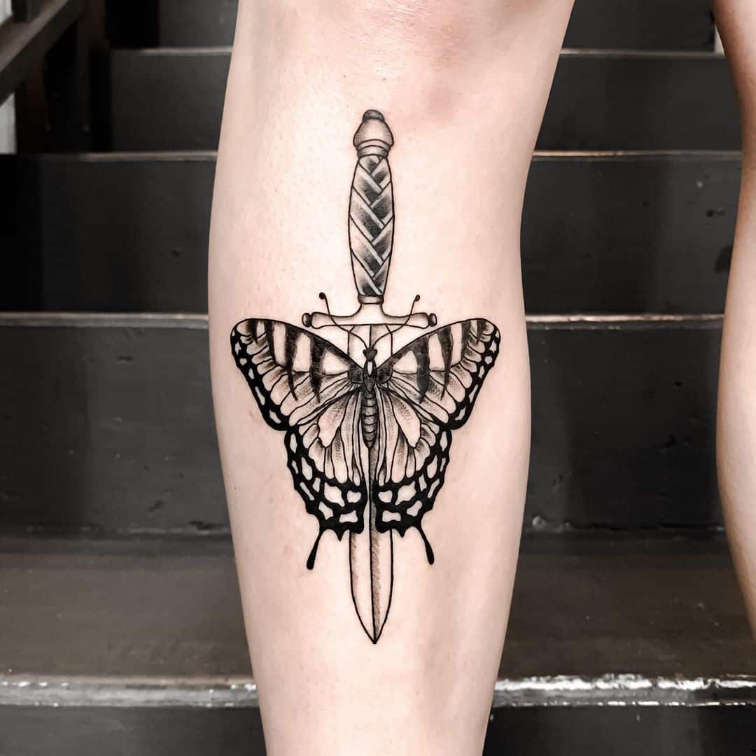 Butterfly dagger tattoo on leg