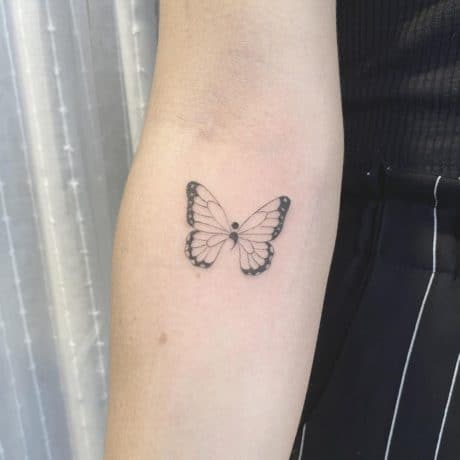 Lovely semi colon butterfly tattoo on arm