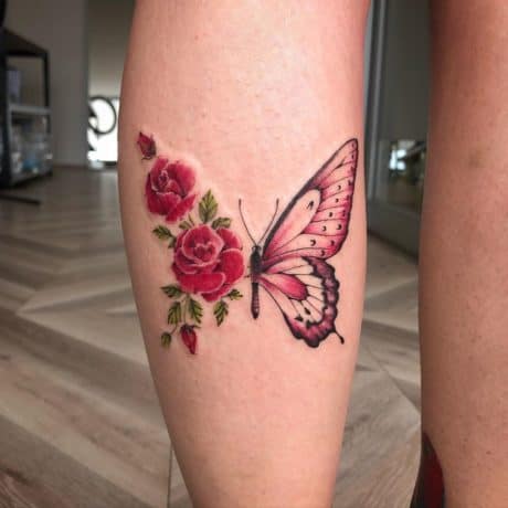 Red floral butterfly tattoo on leg