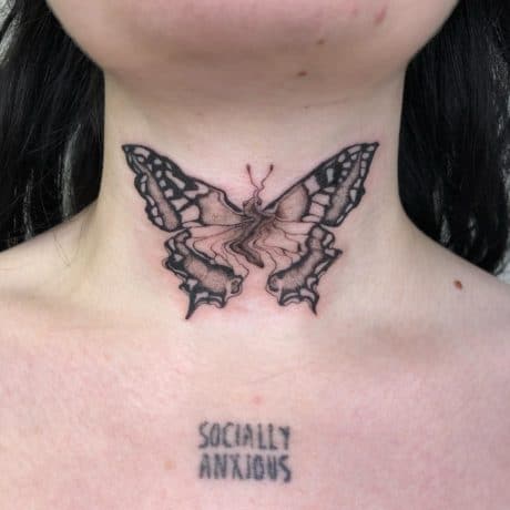 distorted butterfly tattoo on neck by artist heloisegeslain
