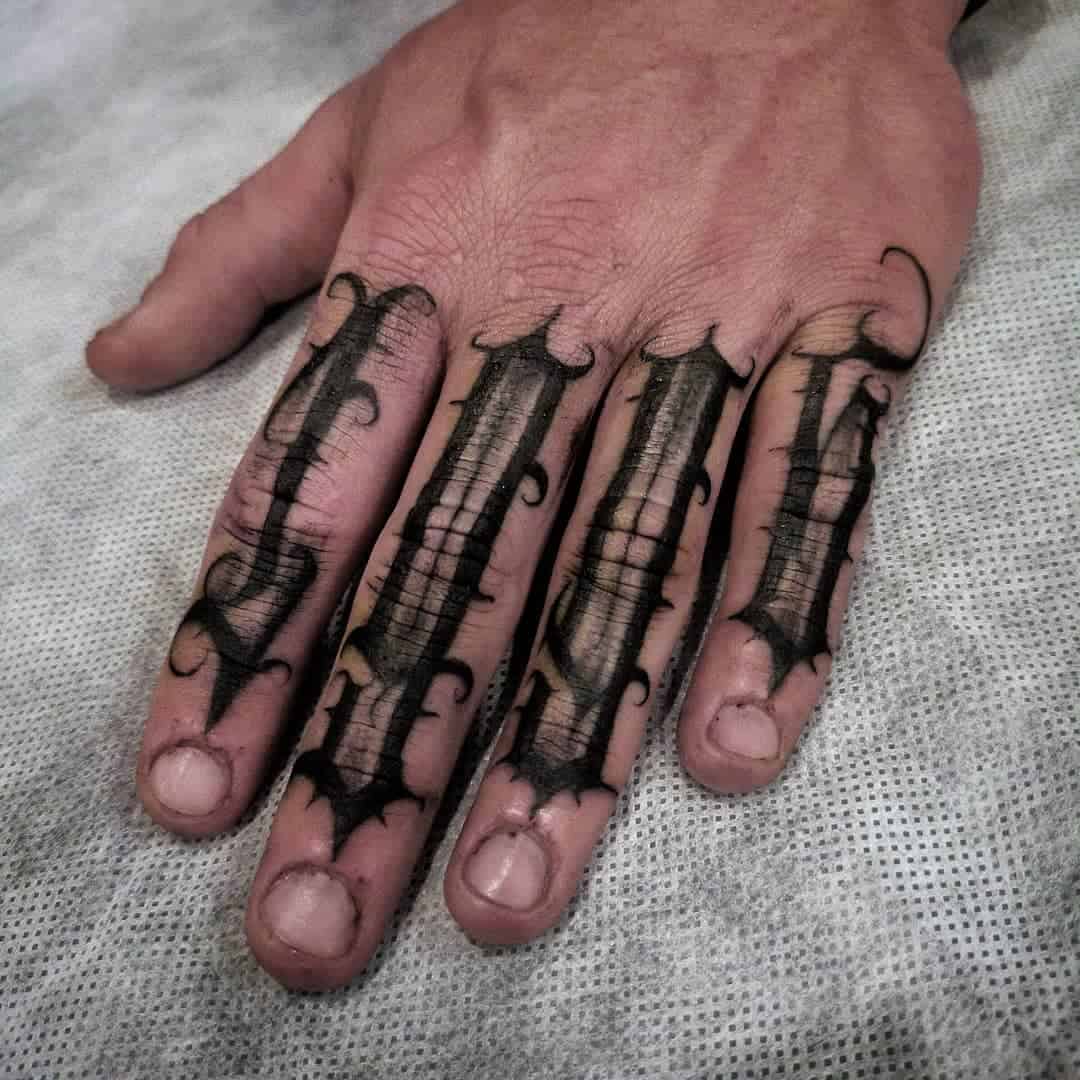 script-tattoo-in-finger-knuckle-by-artist-instiller__