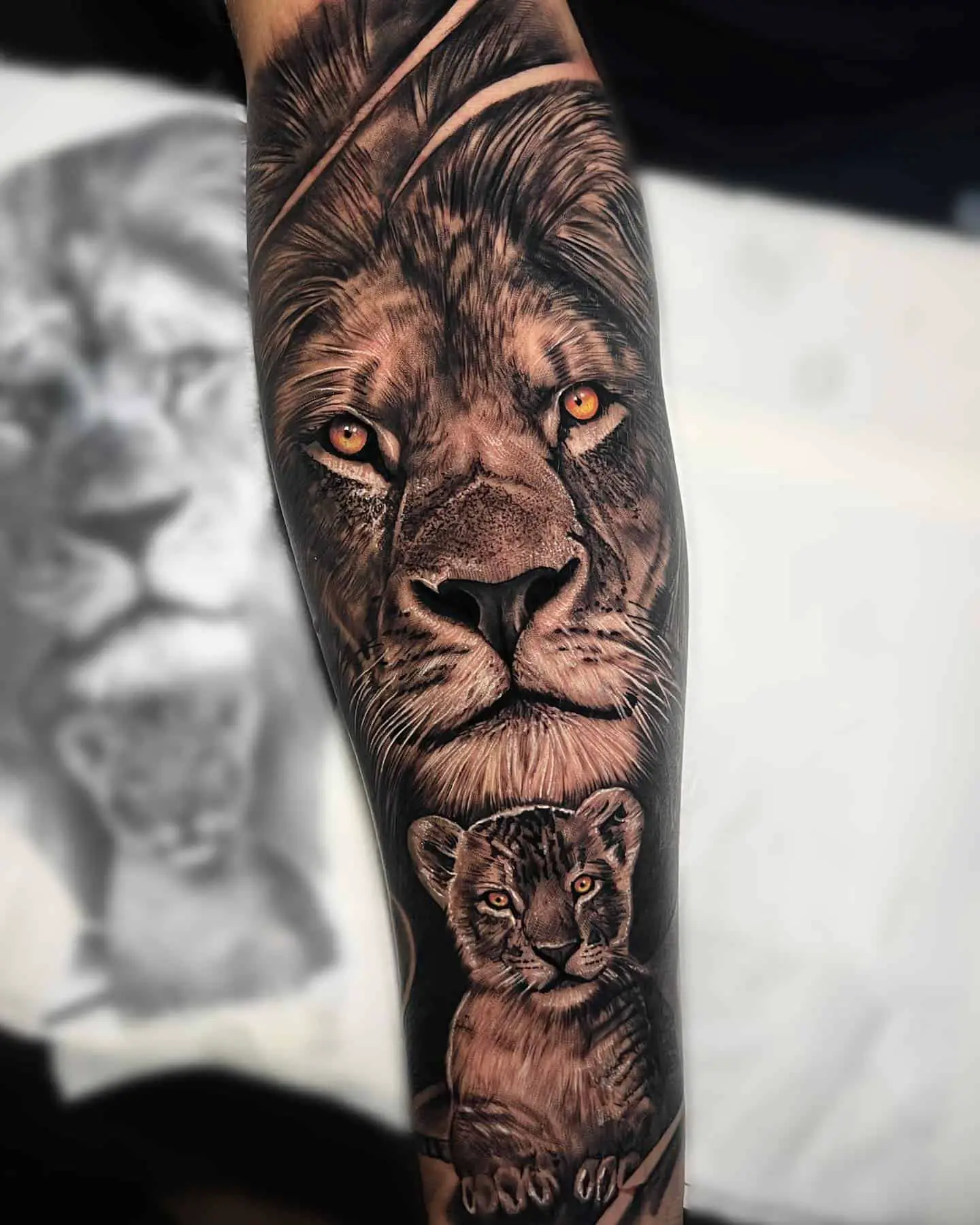black and grey lion and cub tattoo