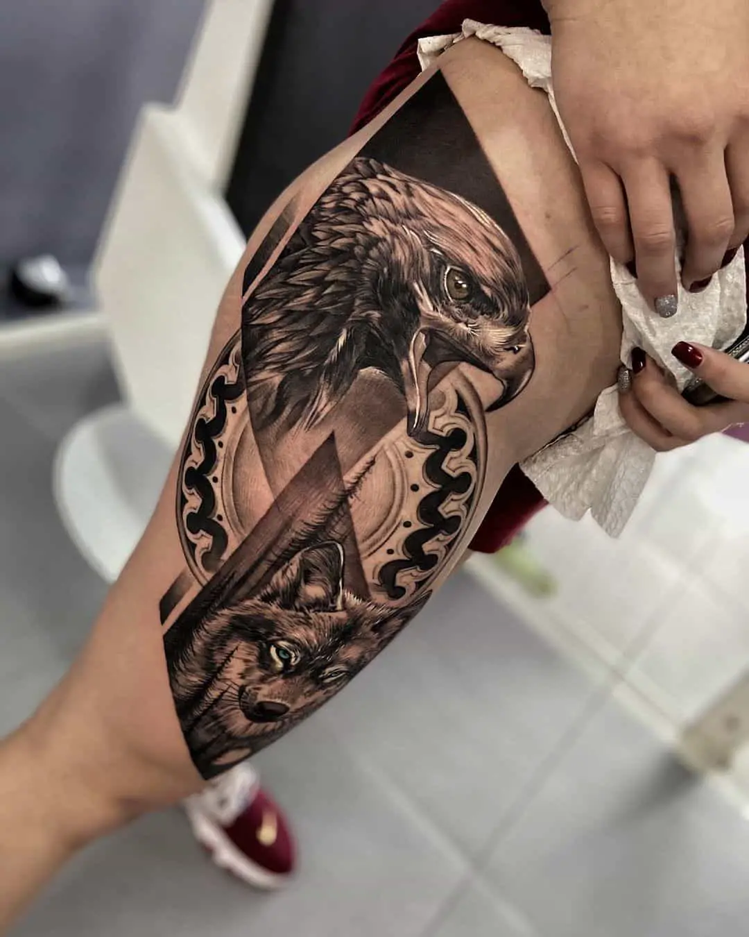 eagle and wolf tattoo on thigh by danielbedoyaart