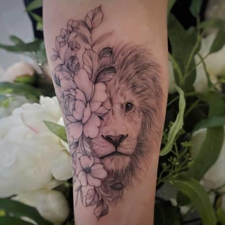 half floral and lion head tattoo