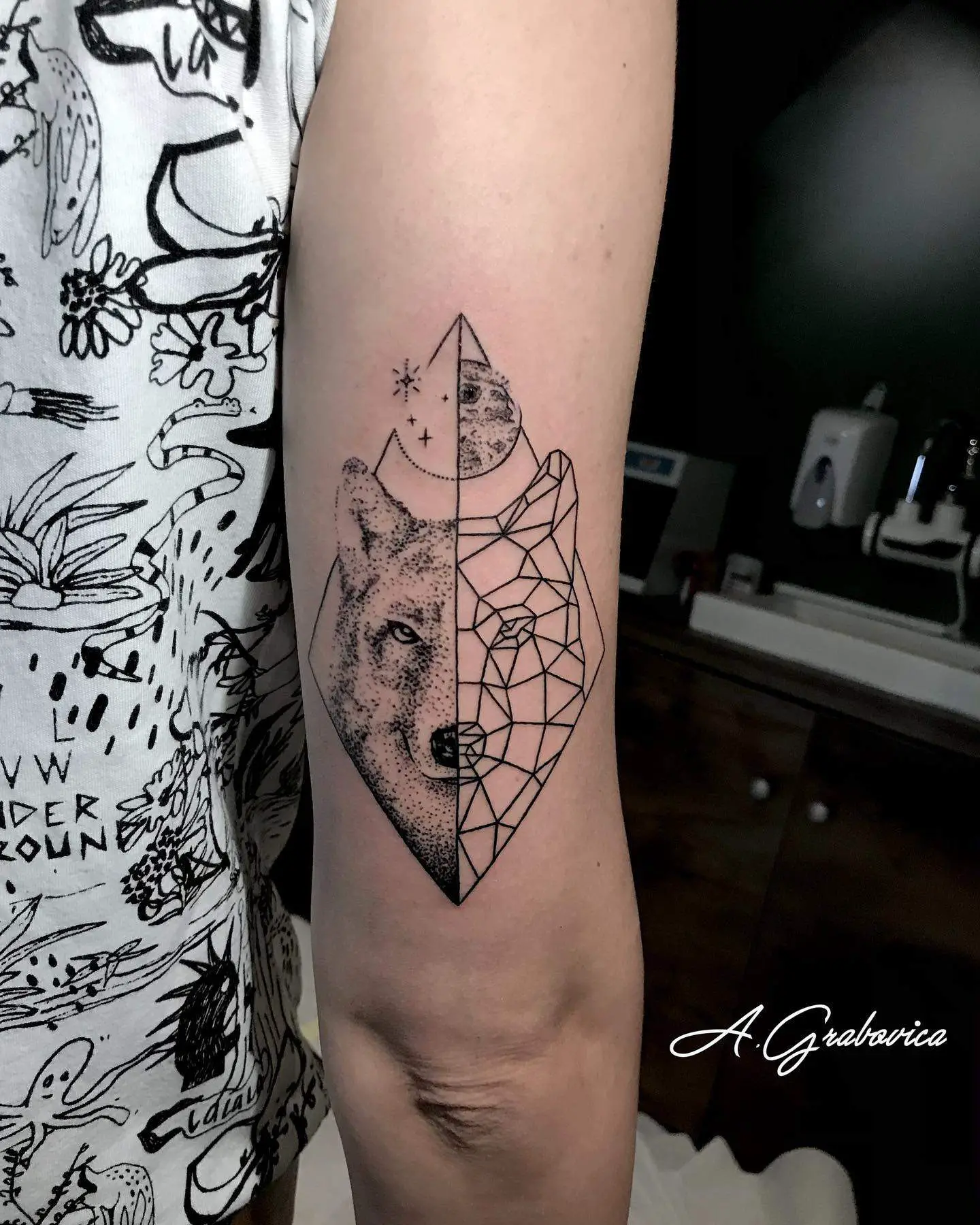 geometric wolf tattoo in arm