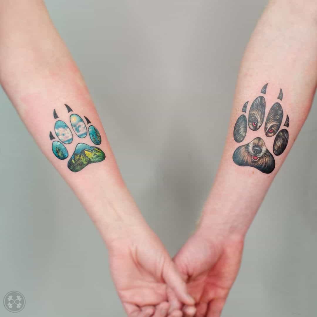 hannah.evolution wolf paw tattoo on forearm