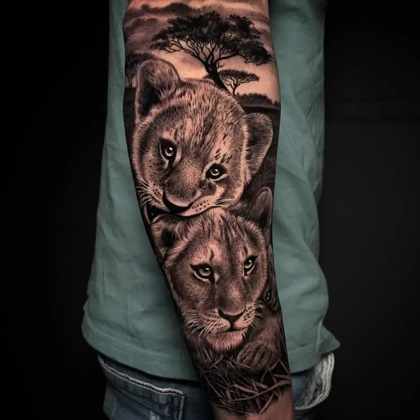 lion cub tattoo on arms