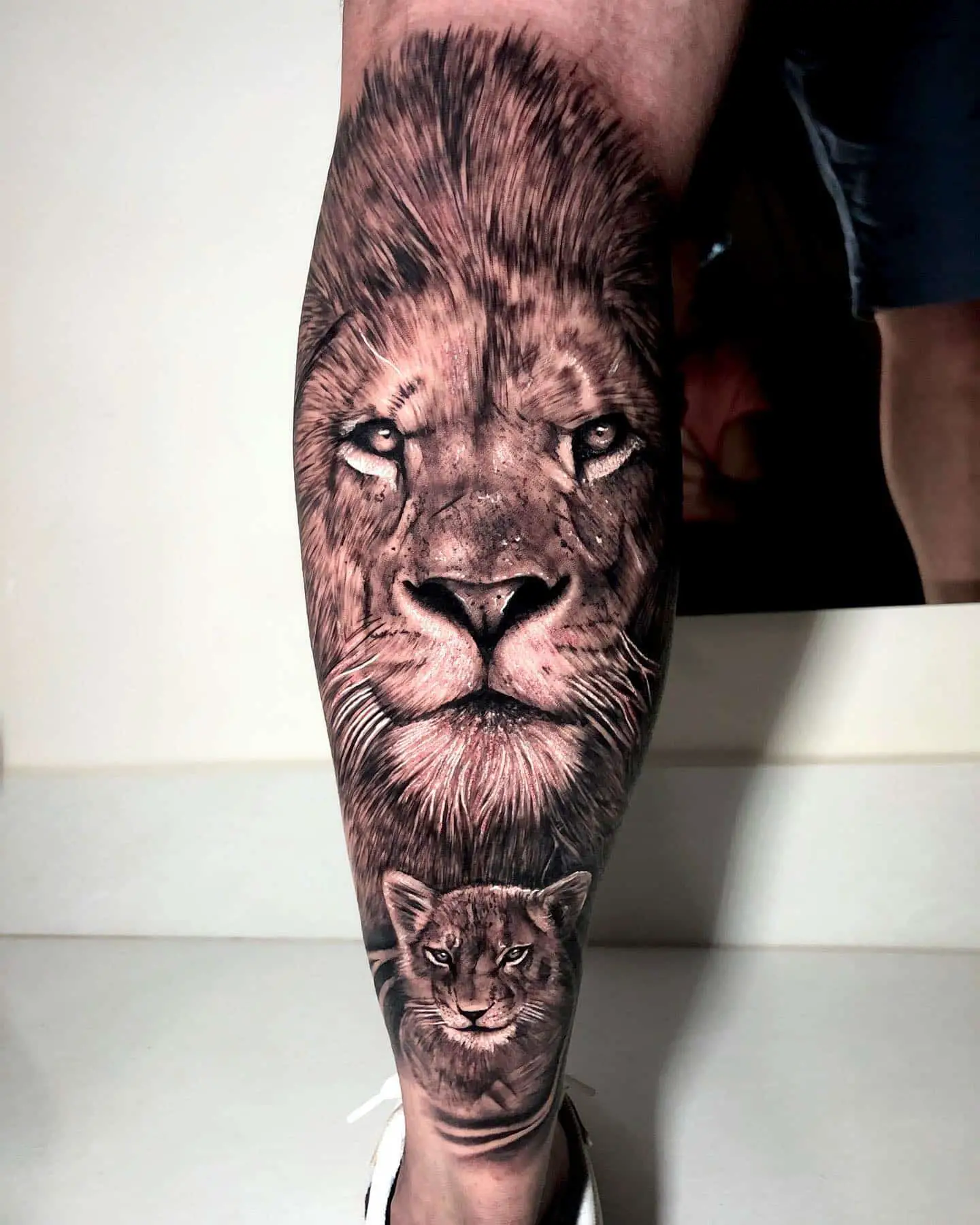 lion and cub tattoo on leg