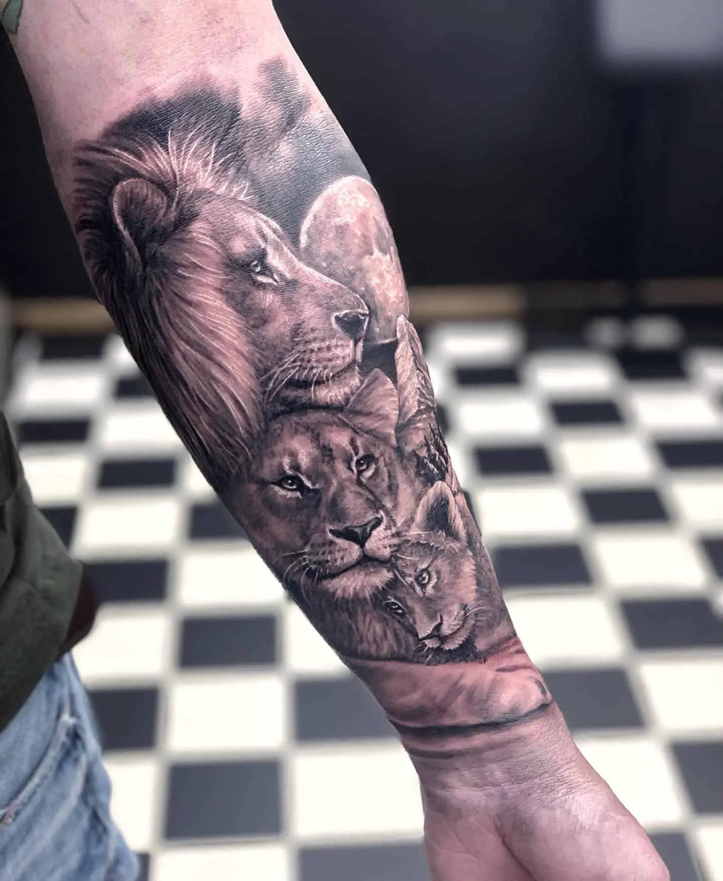 lion family tattoo on forearm