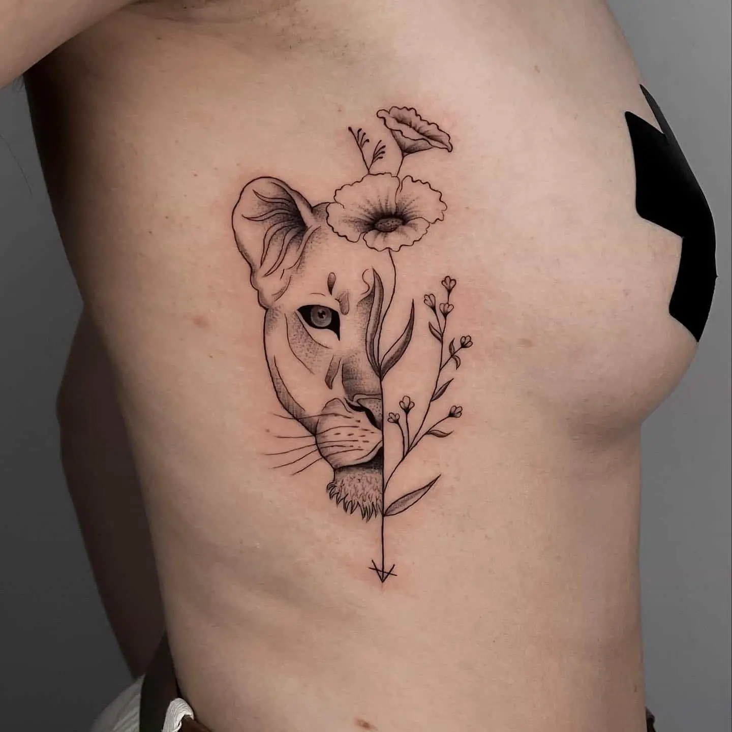 lioness tattoo on women ribs