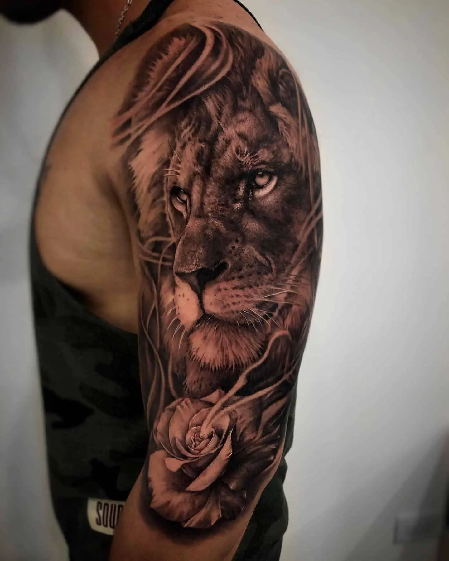 realistic rose and lion black and grey tattoo