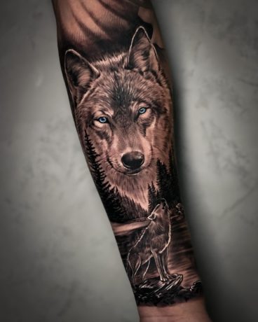 staring wolf tattoo in arm
