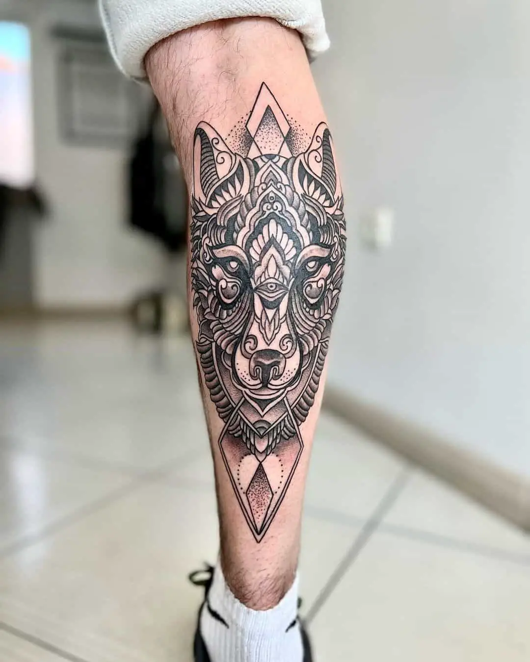 tribal style wolf tattoo on leg by zers tatoo