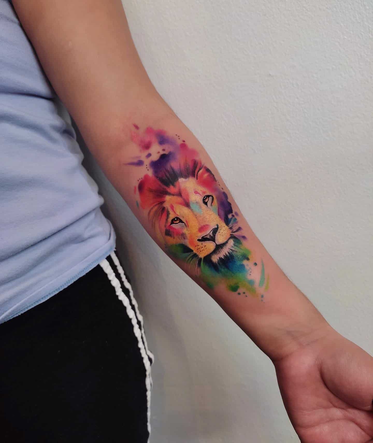 watercolor lion head tattoo on hand