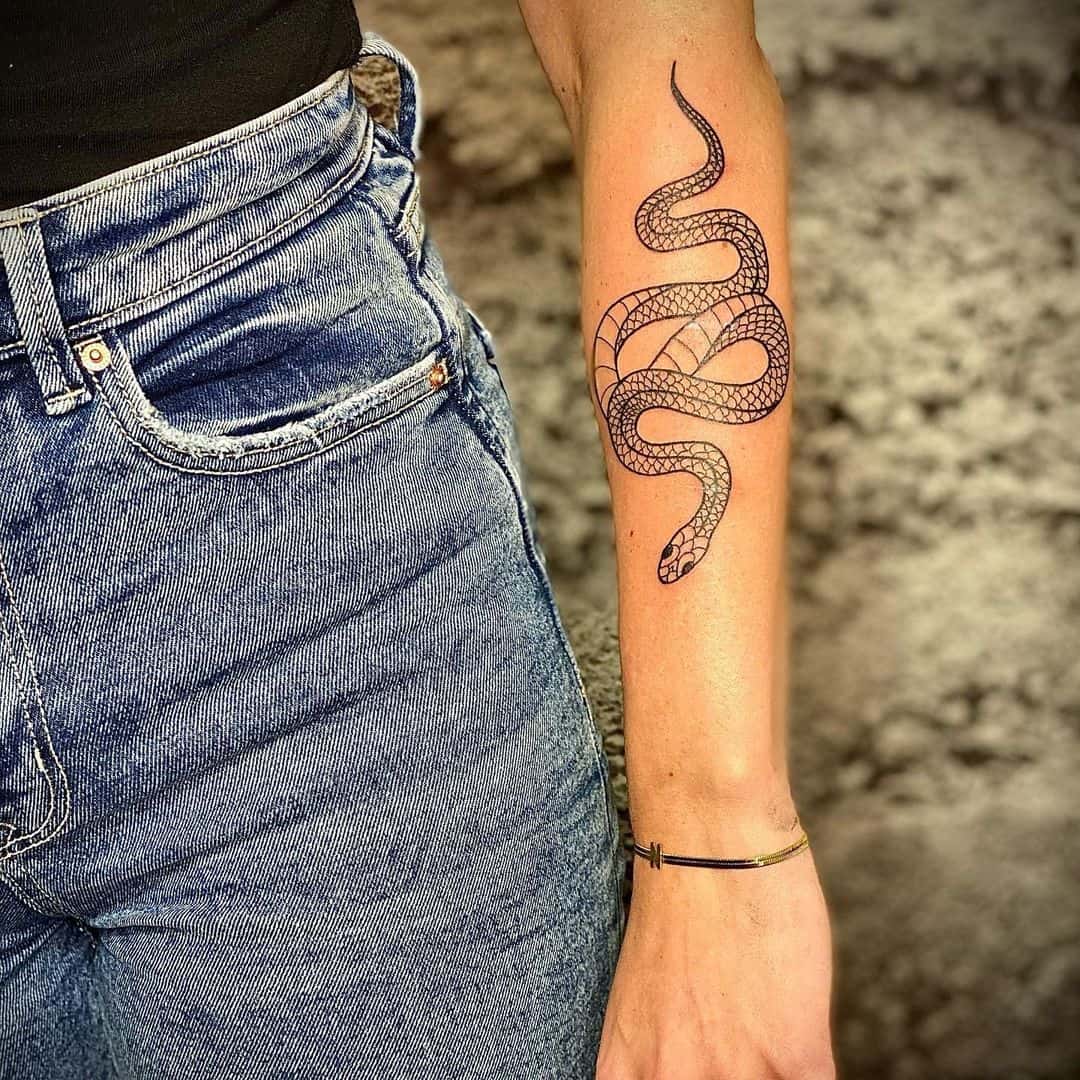 simple snake tattoo on forearm 