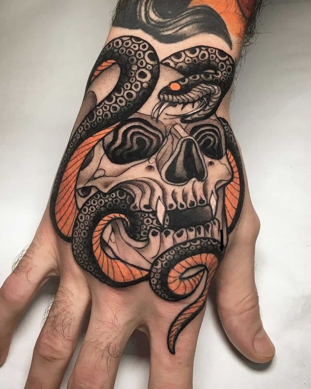 skull and snake tattoo on hand