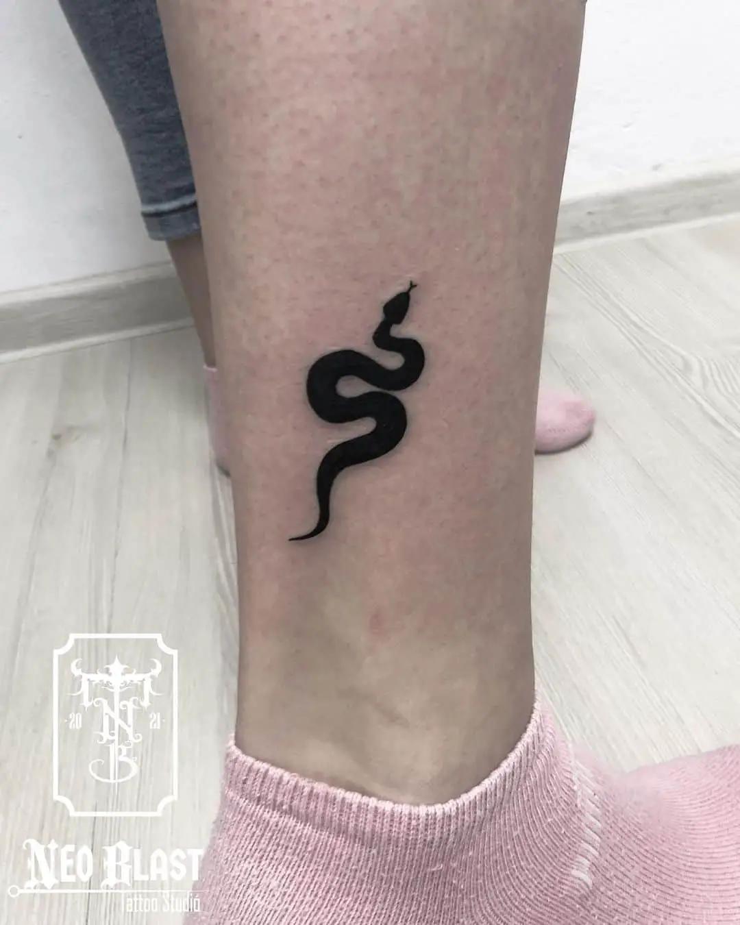black inked snake tattoo