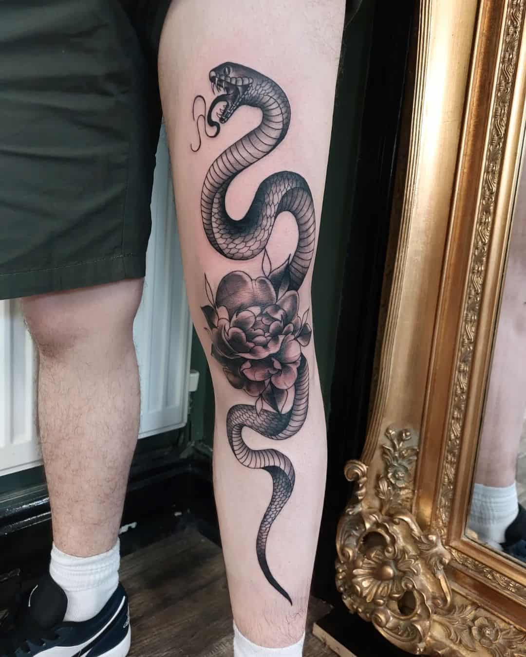 flower and snake tattoo on knee