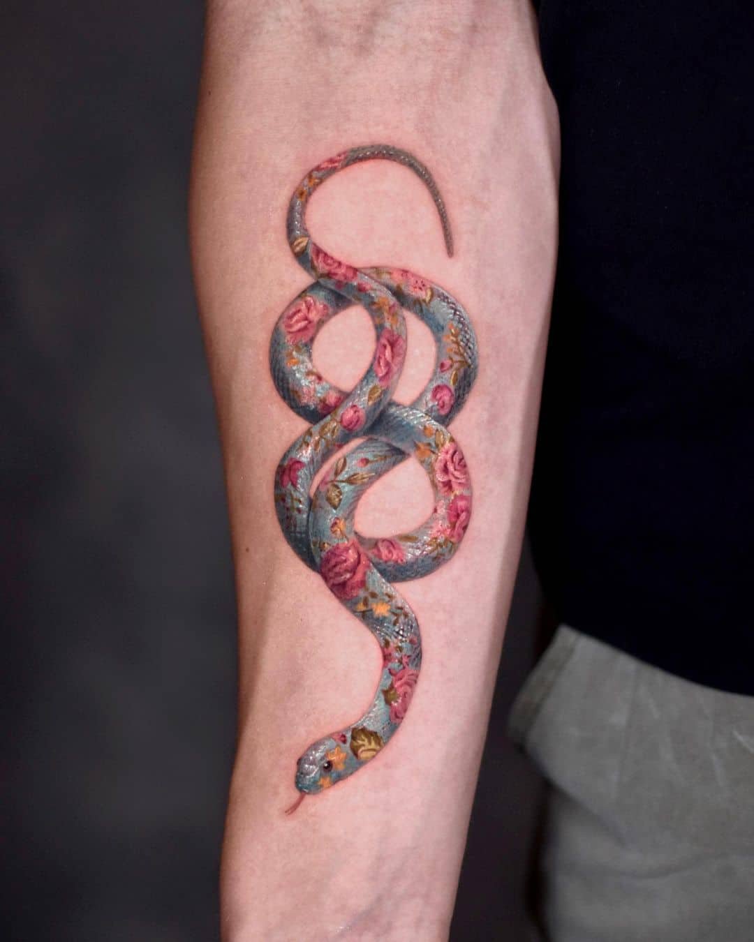 flower and snake tattoo on arm