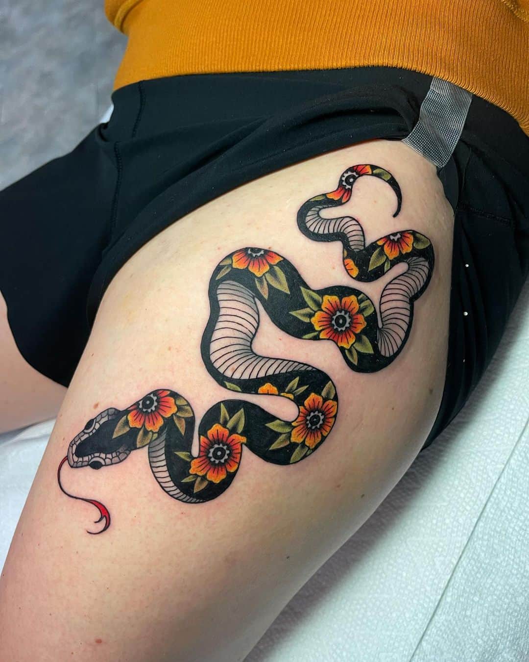 black and yellow flower and snake tattoo