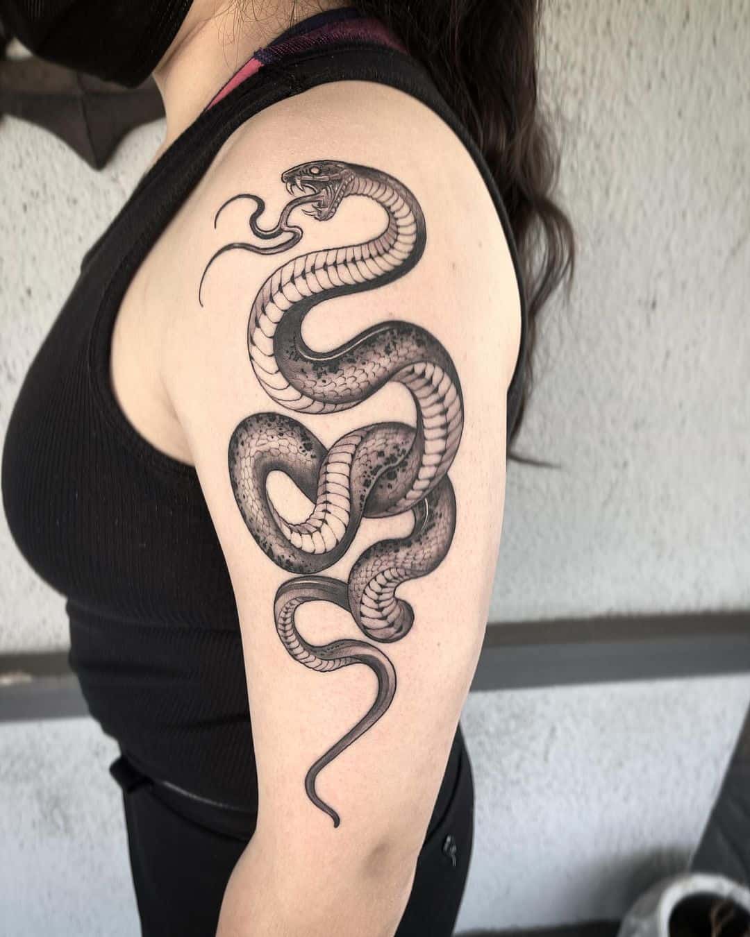 big snake tattoo on arm