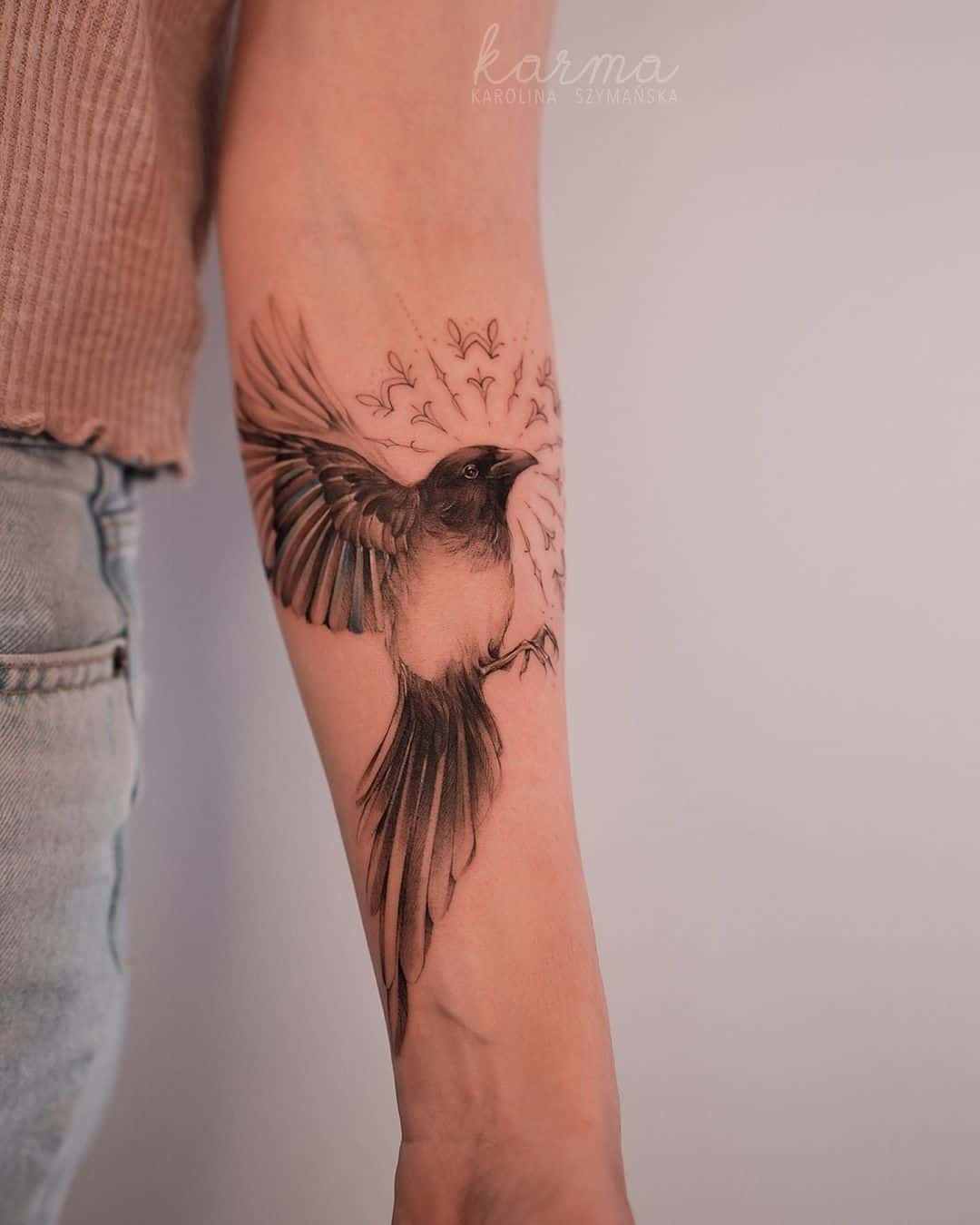 beautiful bird tattoo on forearm