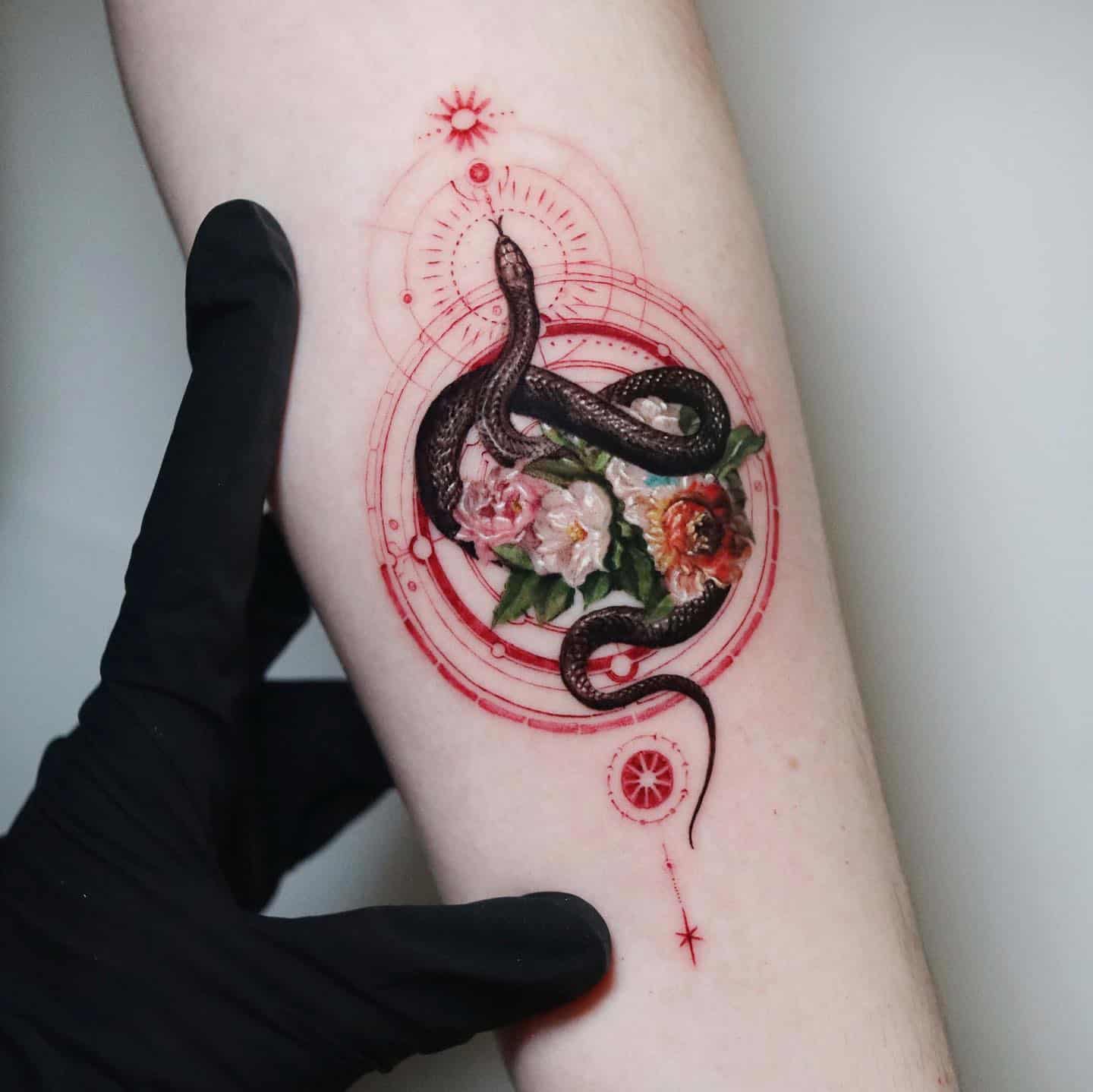 black snake with beautiful flower on arm