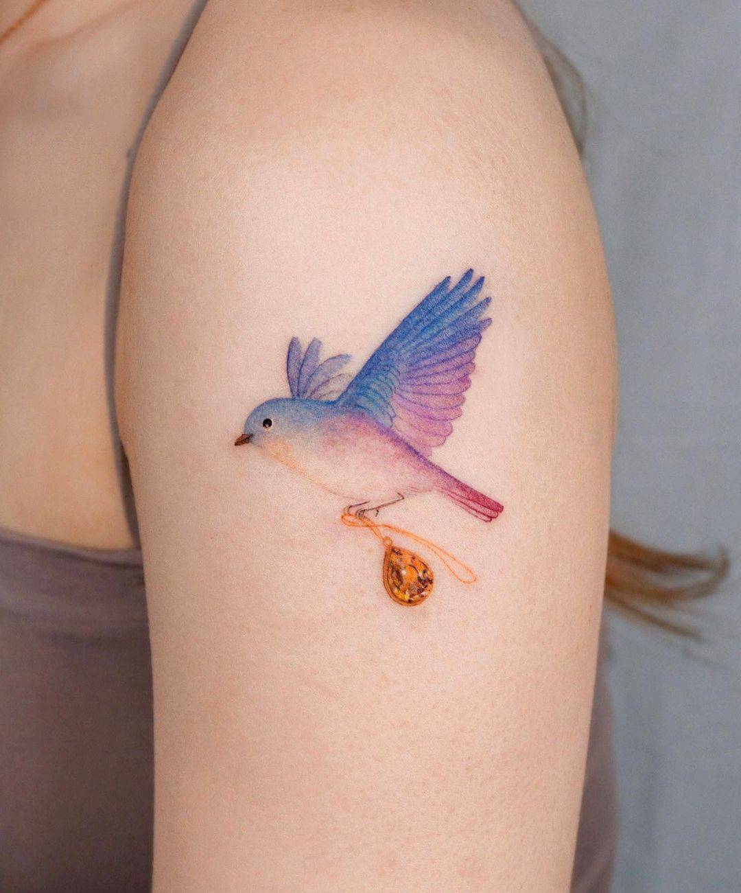 beautiful colored sparrow tattoo on am