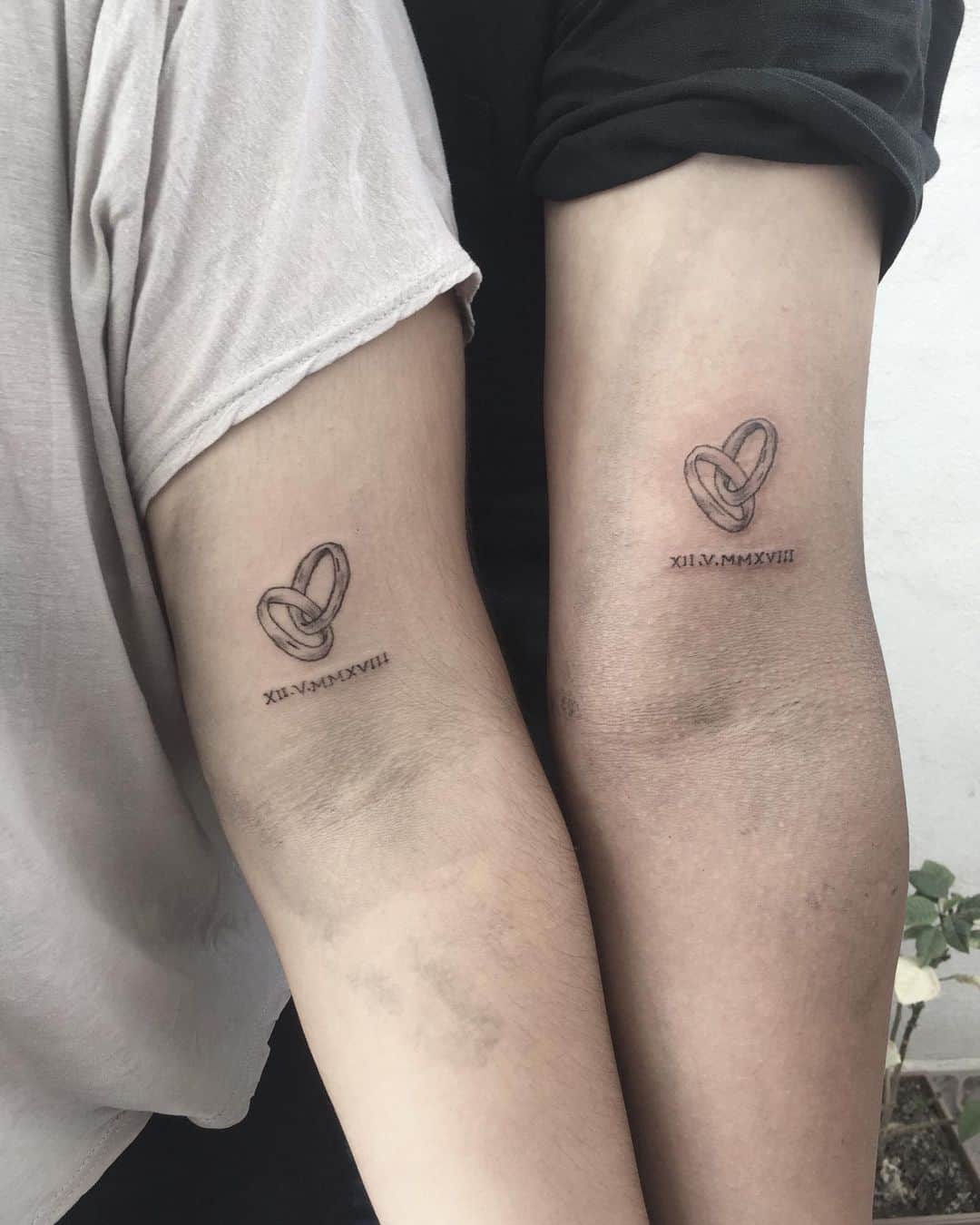 couple matching tattoo on arm