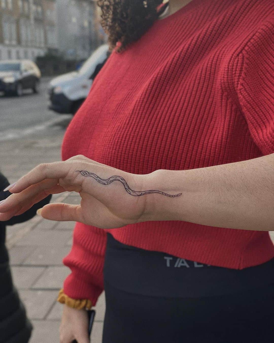 small snake tattoo on hand