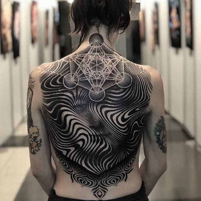 geometric face tattoo on back