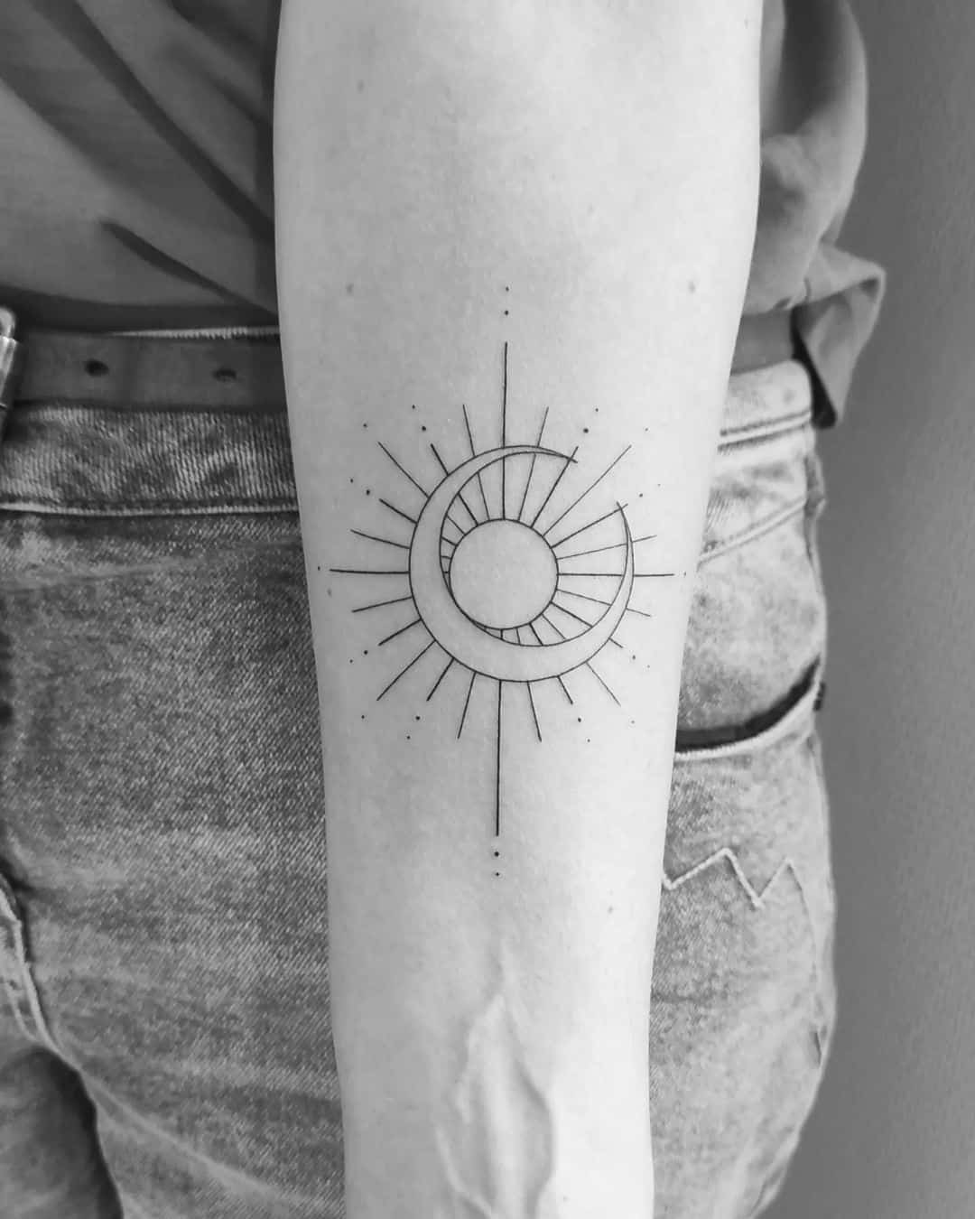 sun behind the moon tattoo
