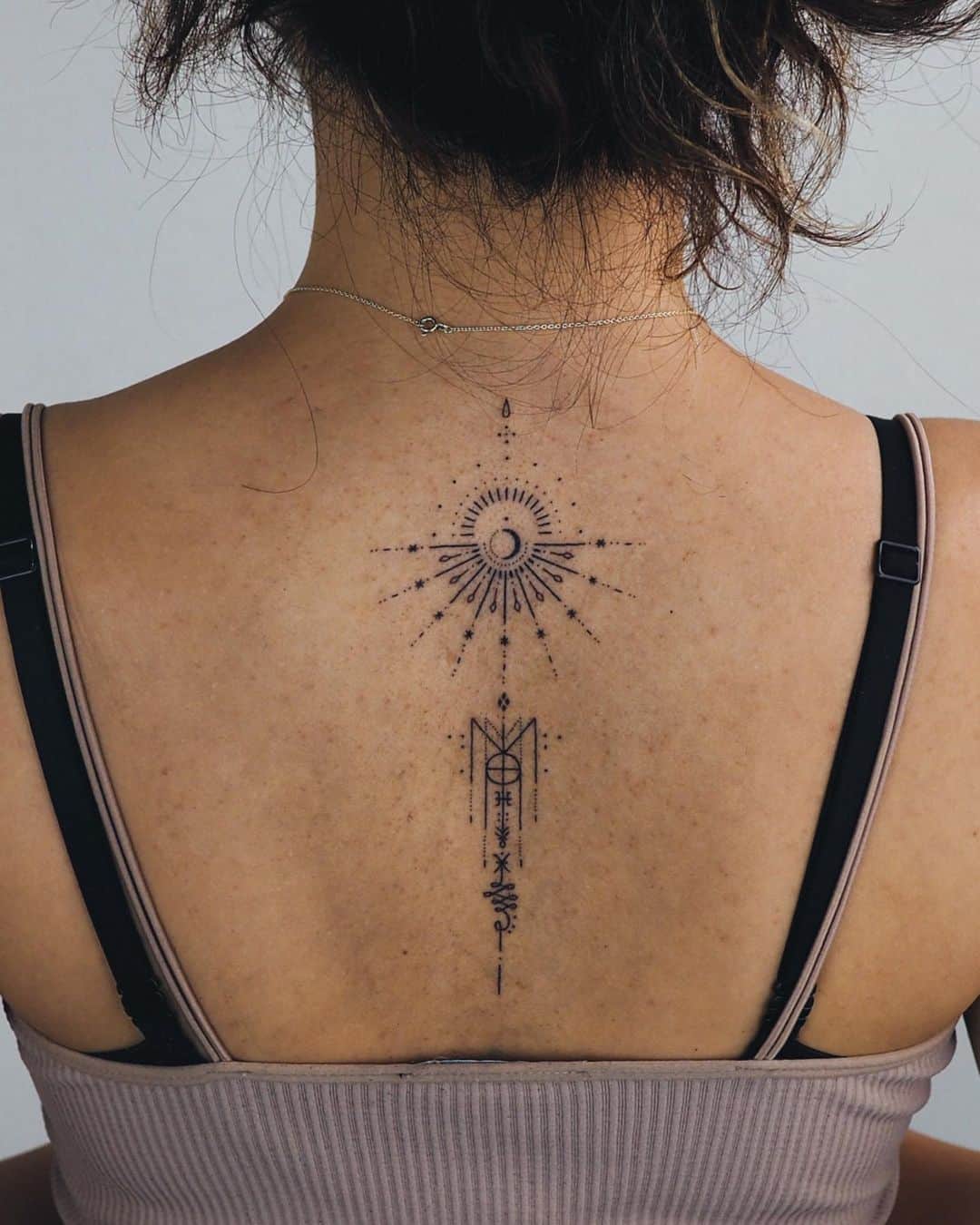 sun tattoo on back