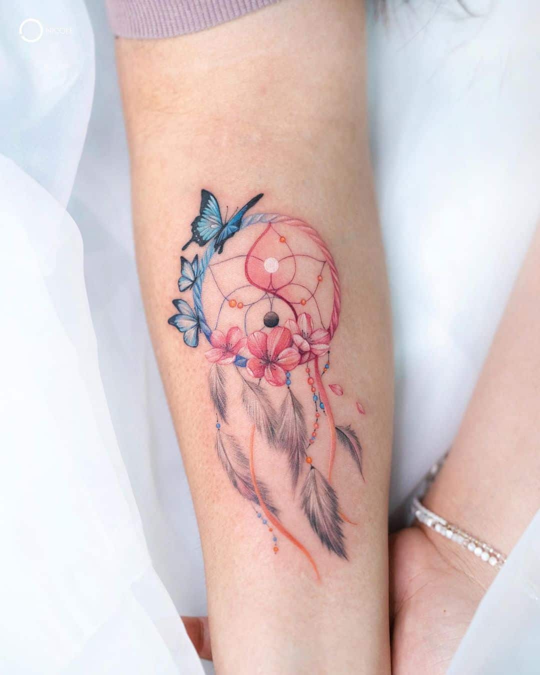 pink colored dream catcher tattoo