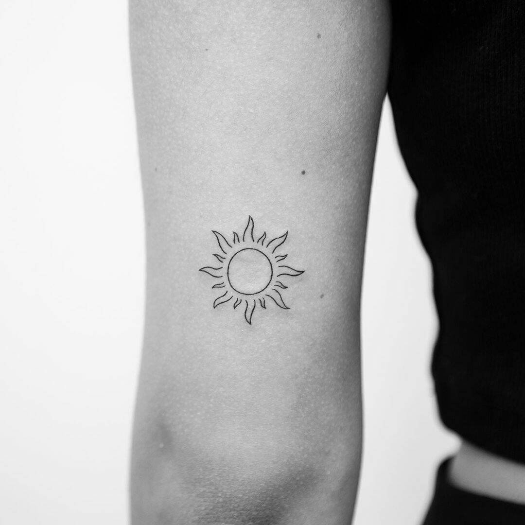 sun tattoo on arm