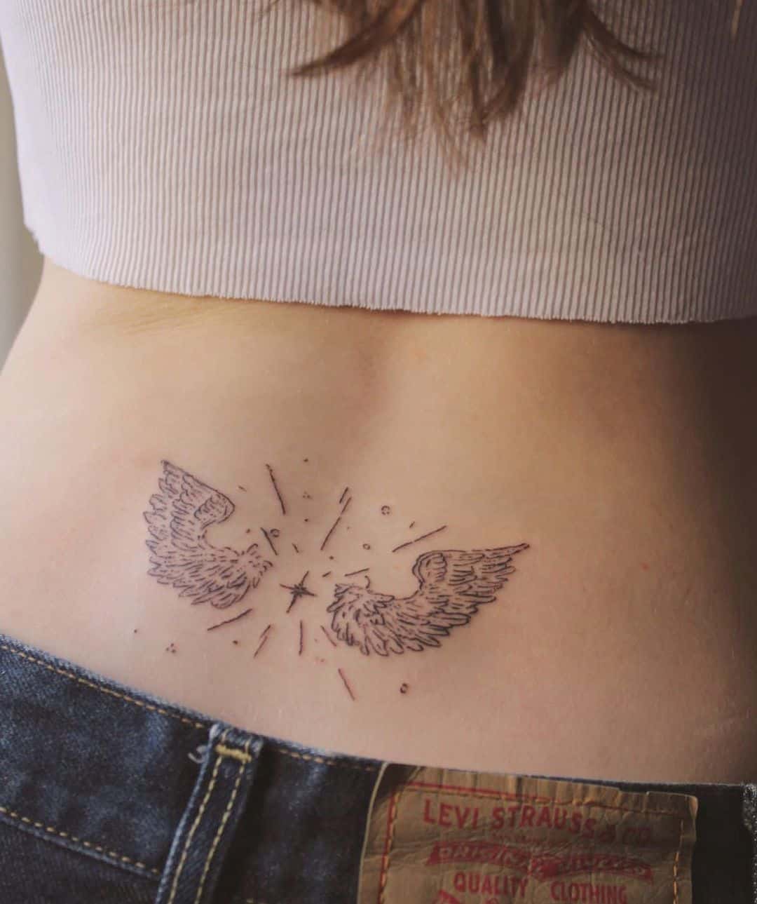 wings tattoo on waist