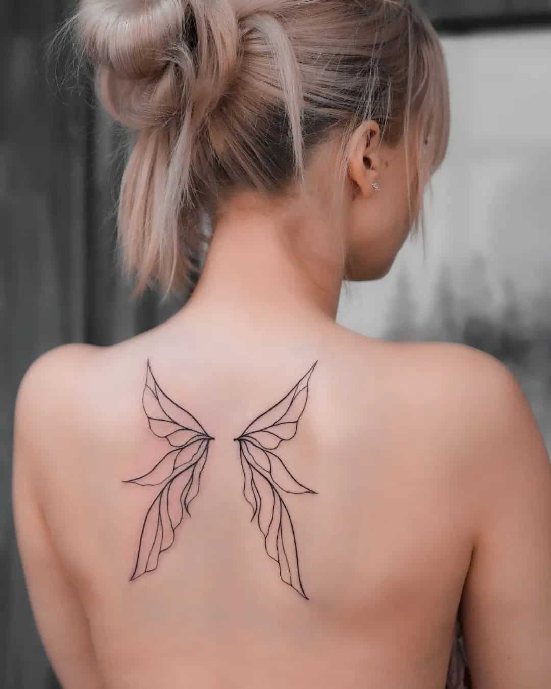 lined winged tattoo on back