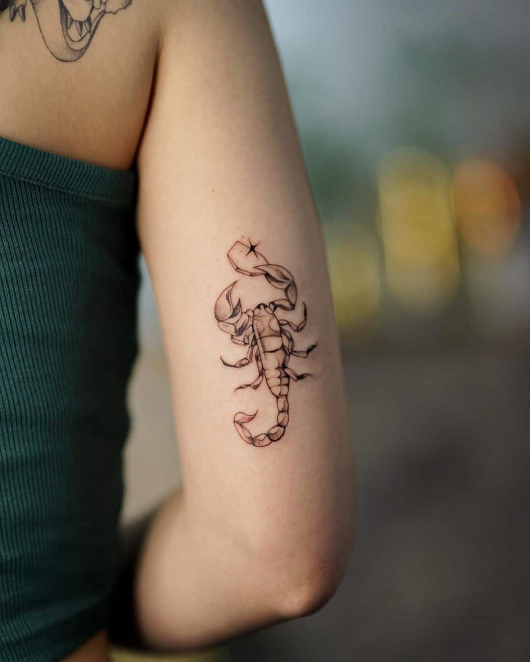 Micro-realistic scorpion and flower tattoo located on