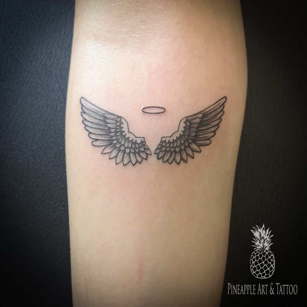 Angel wings with halo tattoo