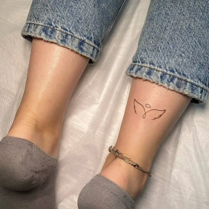 Angel wing tattoo on leg