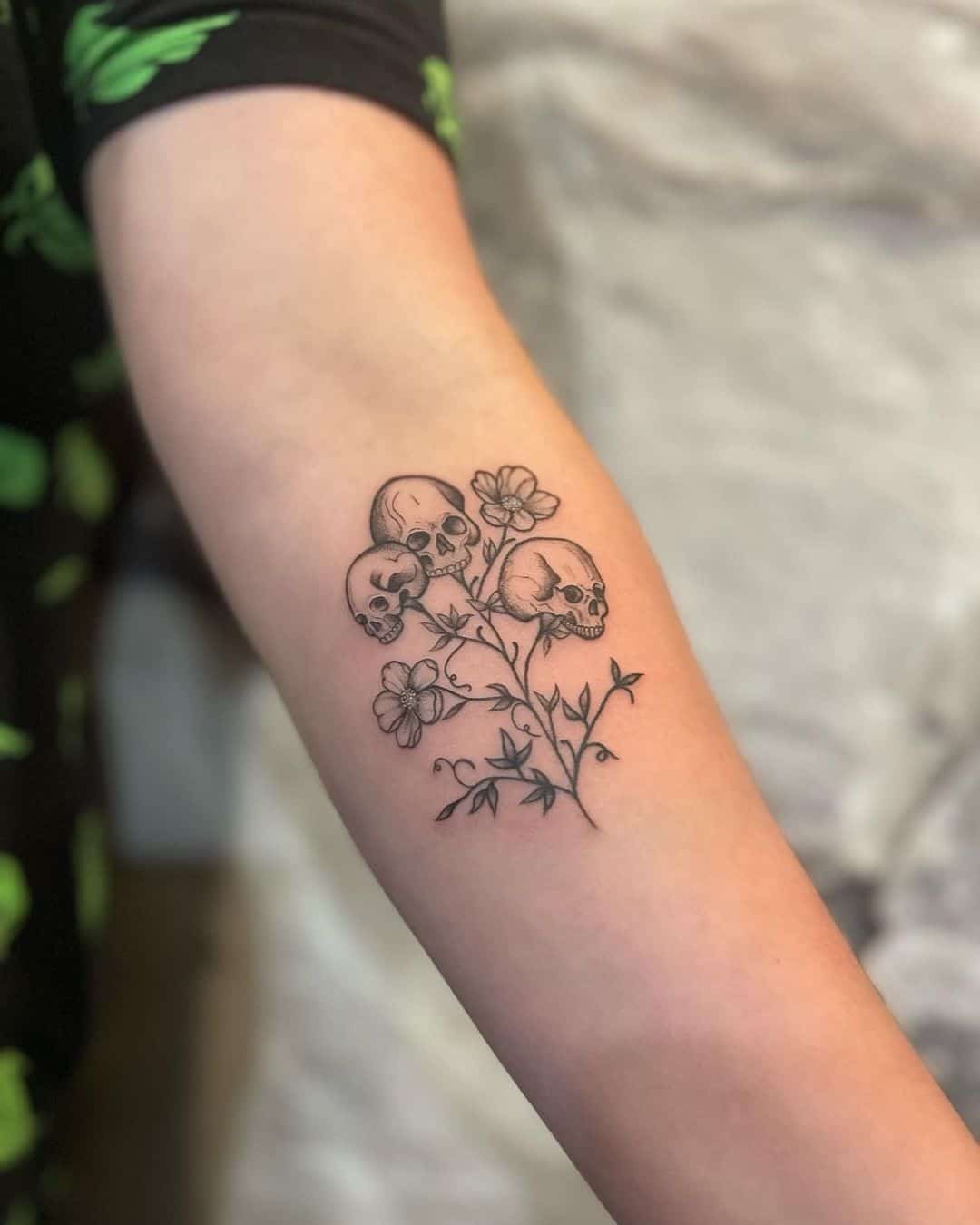 Skull and flower tattoo design