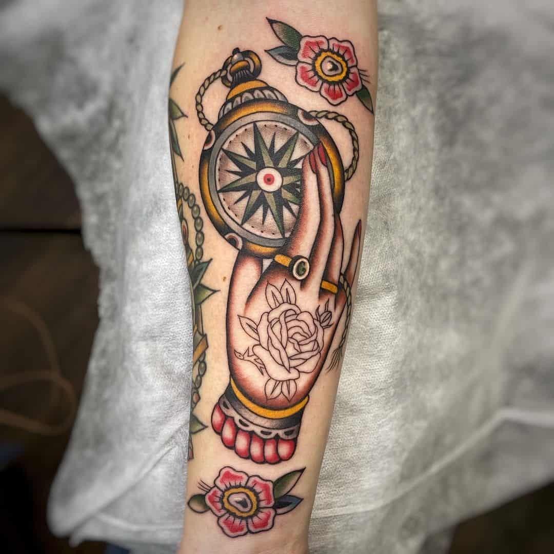 Traditional compass tattoo with hand