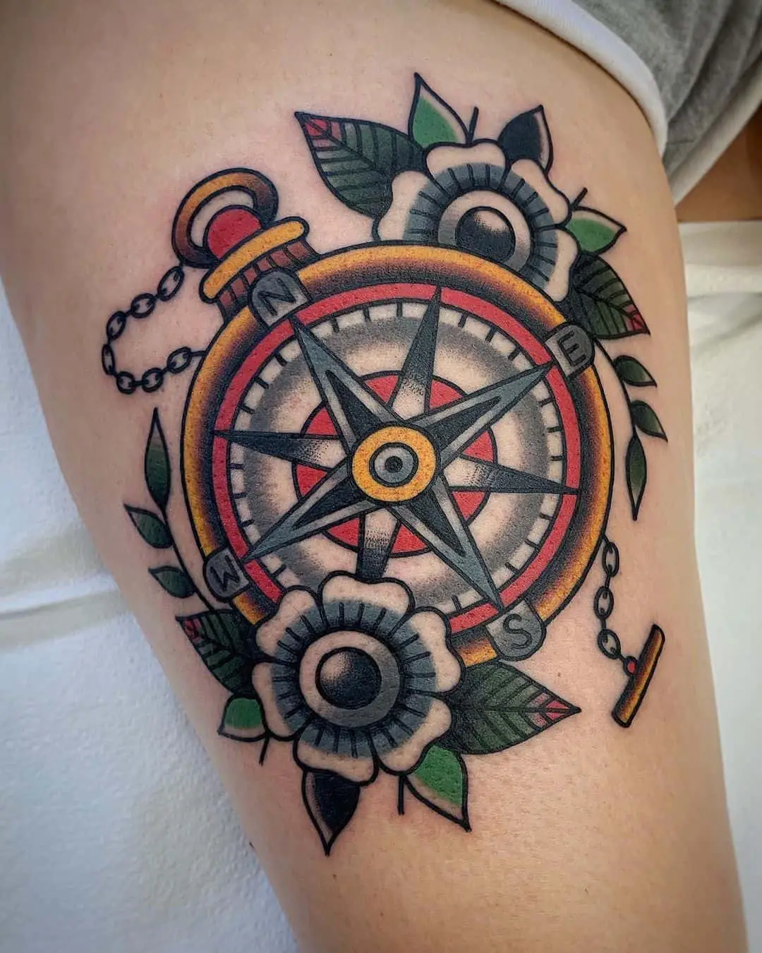 Traditional compass and flower tattoo 