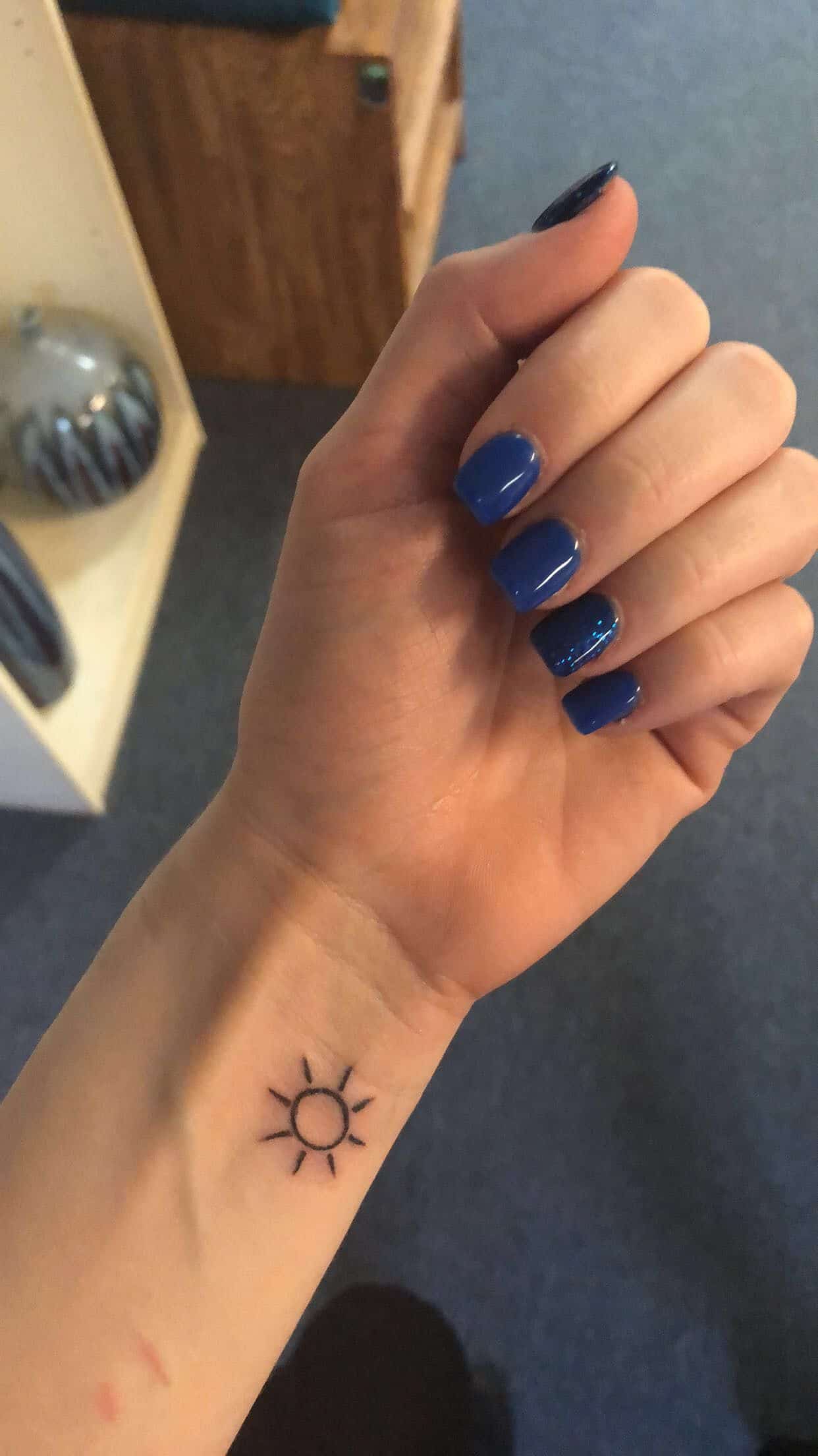 Simple Sun tattoo idea for the wrist