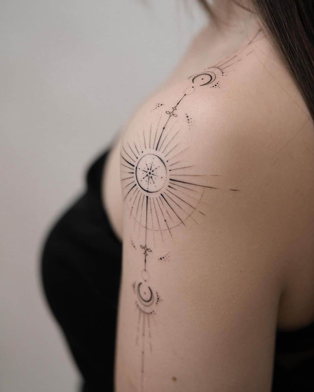 Geometric sun tattoo on shoulder