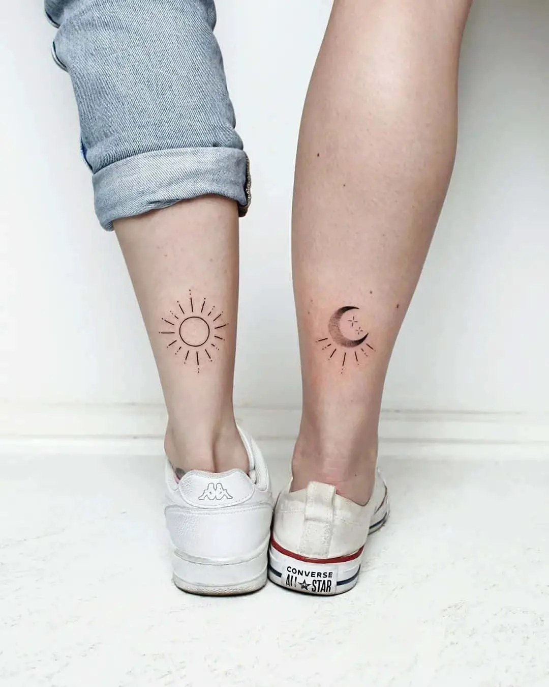 Sun and moon tattoo on lower leg